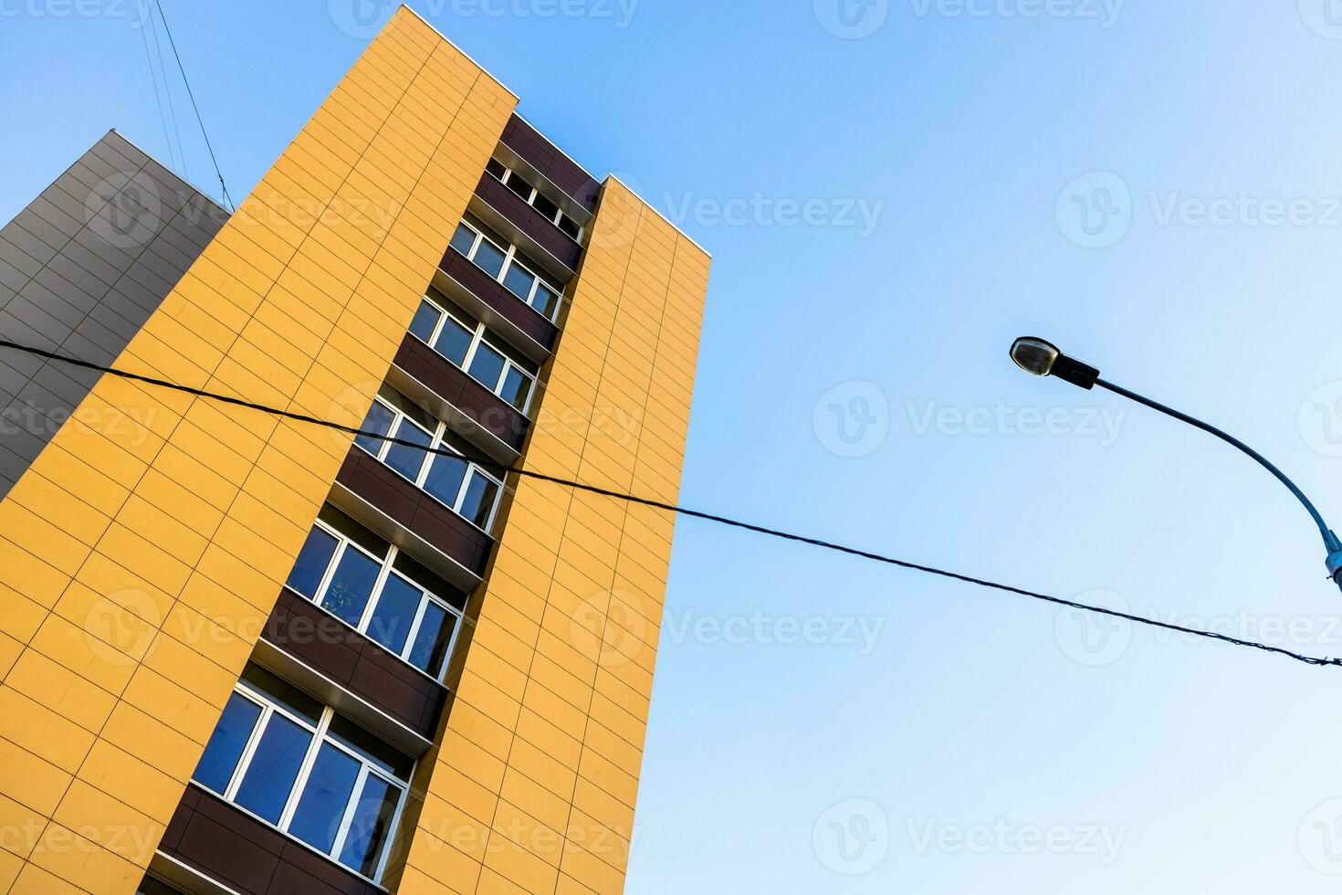 yellow house, city lamp with wire and blue sky photo