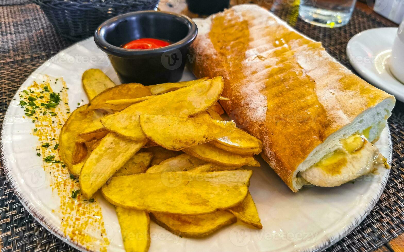 Baguette sandwich toast bread with chicken tomato salad potatoes fries. photo