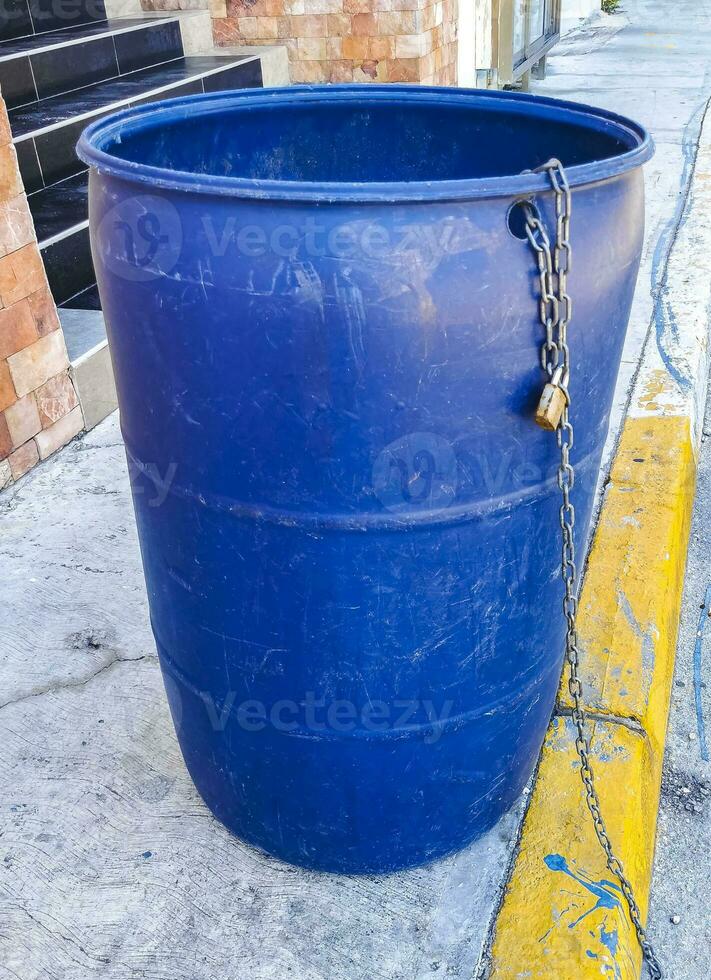 Blue trash garbage cans dirty street Playa del Carmen Mexico. photo