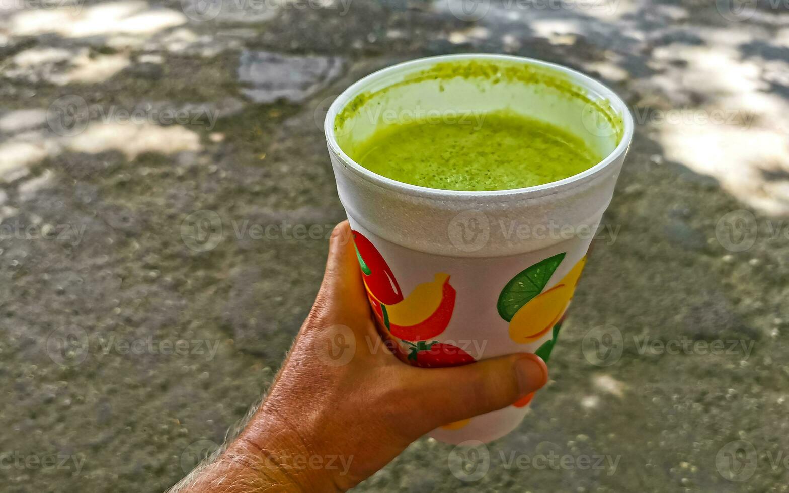 Green healthy juice smoothie in to go cup in Mexico. photo