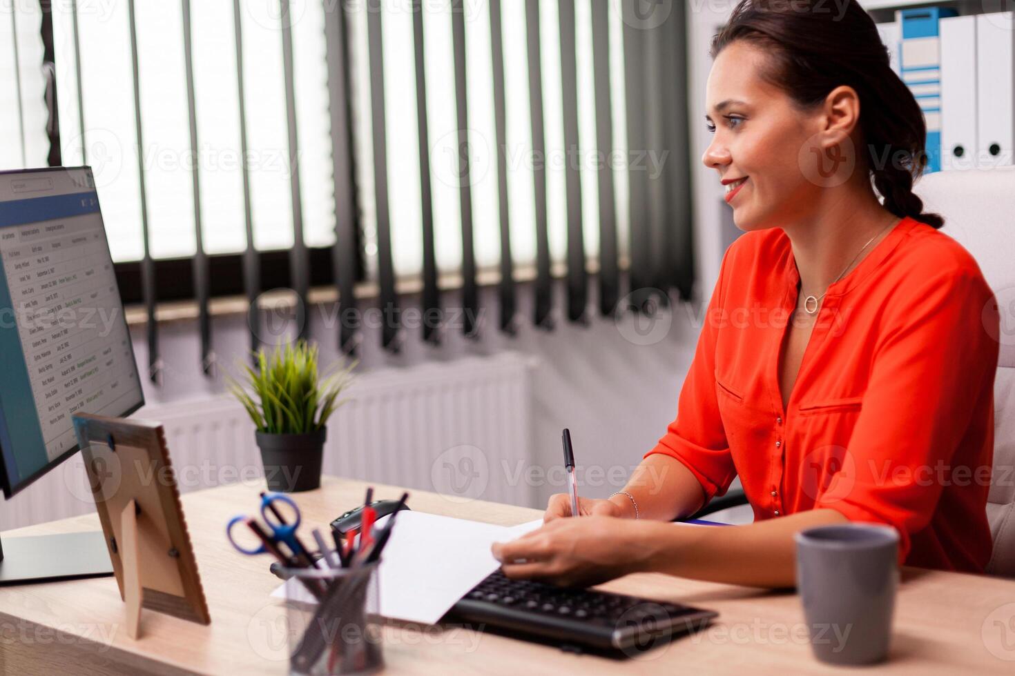 Businesswoman entrepreneur preparing financial presentation looking at analysis charts. Successful financial auditor in data marteking looking at graphs on computer screen and writing report. photo