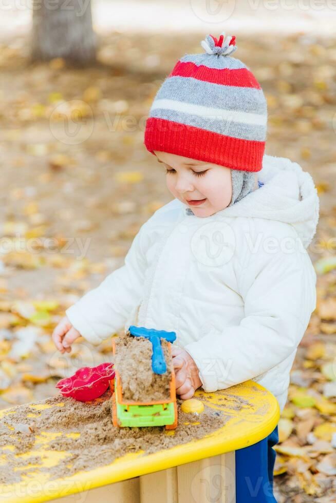 the kid plays cars on the street photo