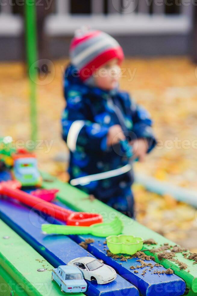 the kid plays cars on the street photo