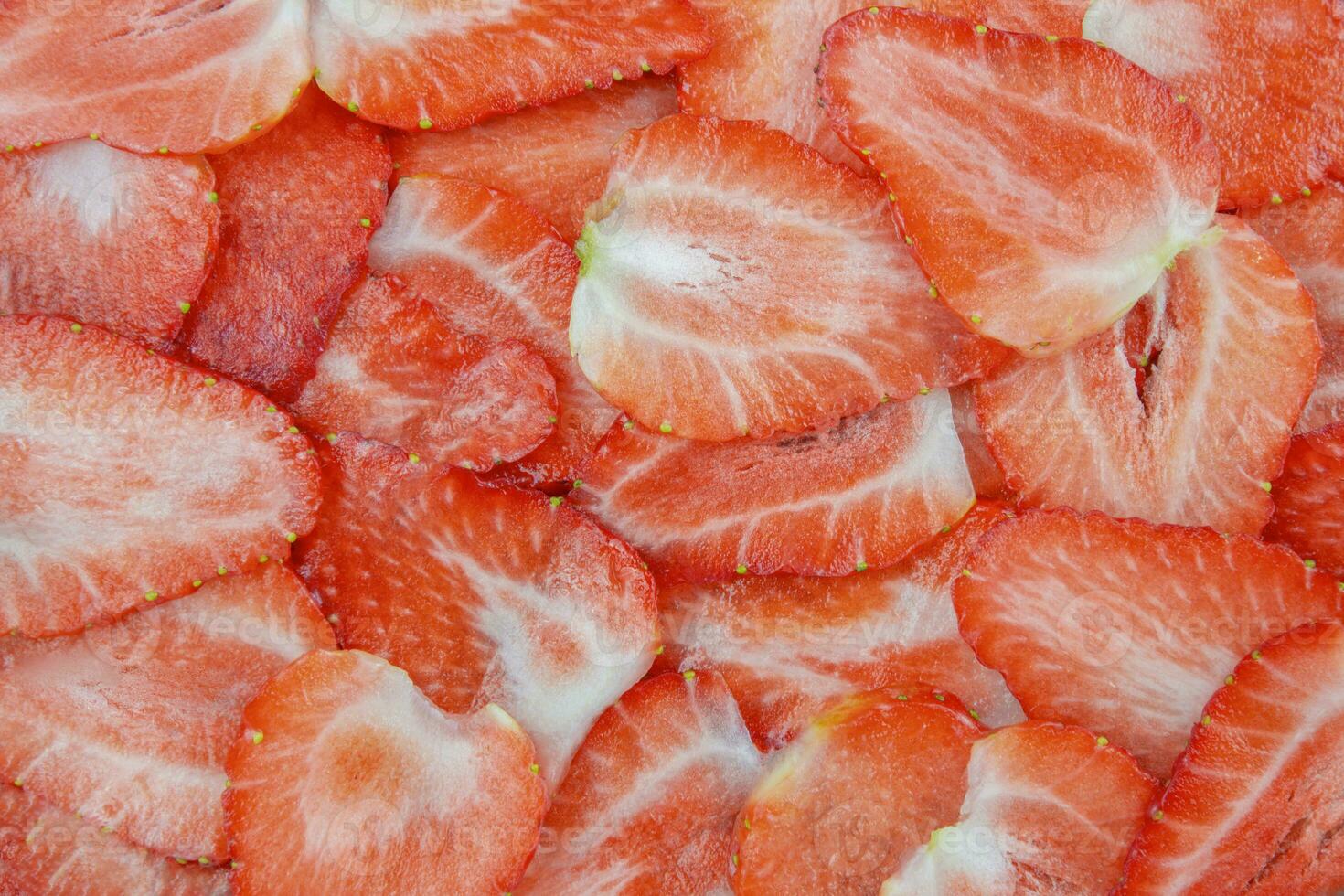 Summer texture of sliced strawberries. Fresh strawberry slice red background. photo