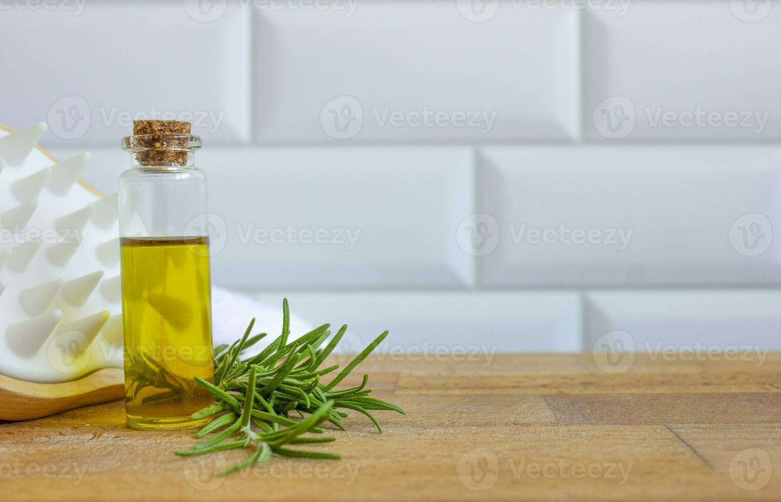 Rosemary oil on a light background. Natural hair care. photo