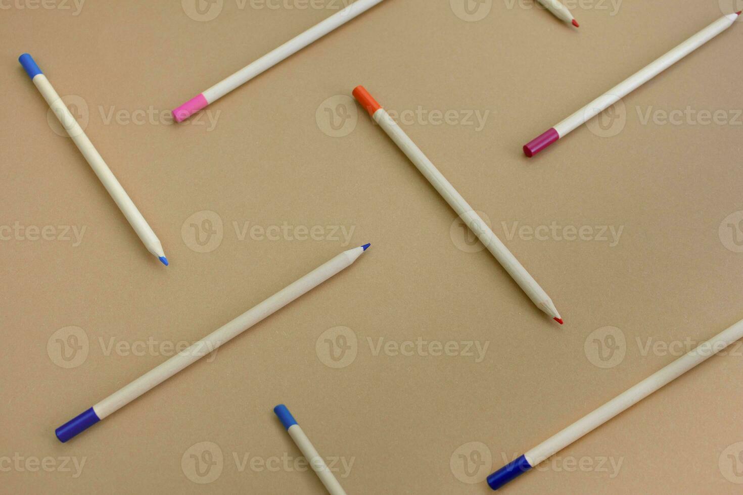 Pencils on a paper background, pattern photo
