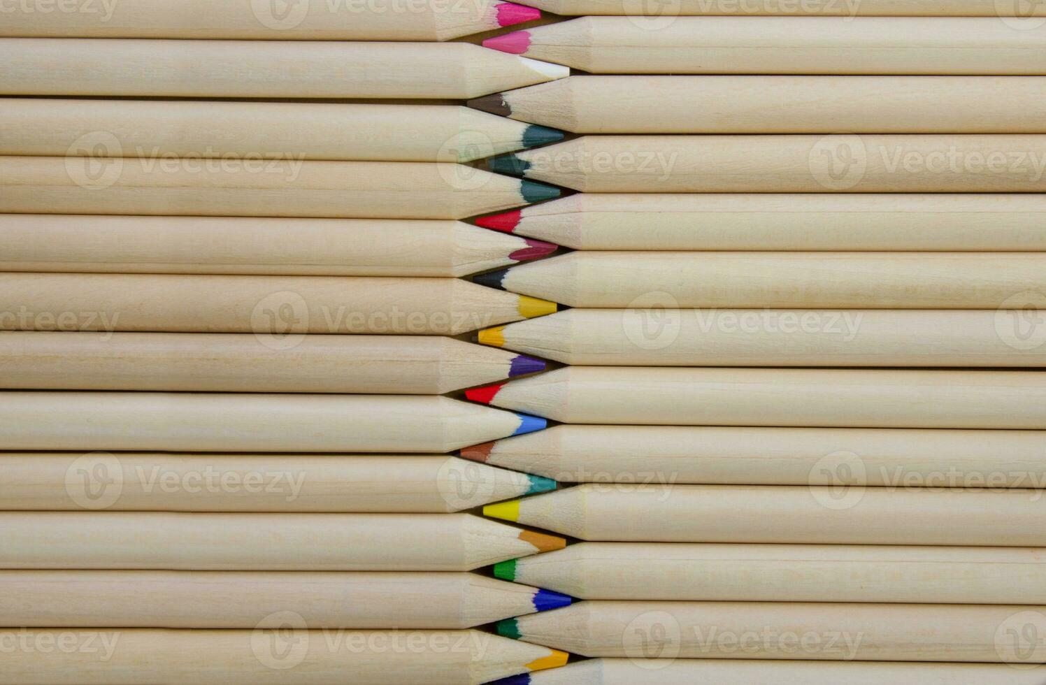 Exactly laid out colored wooden pencils, top view photo