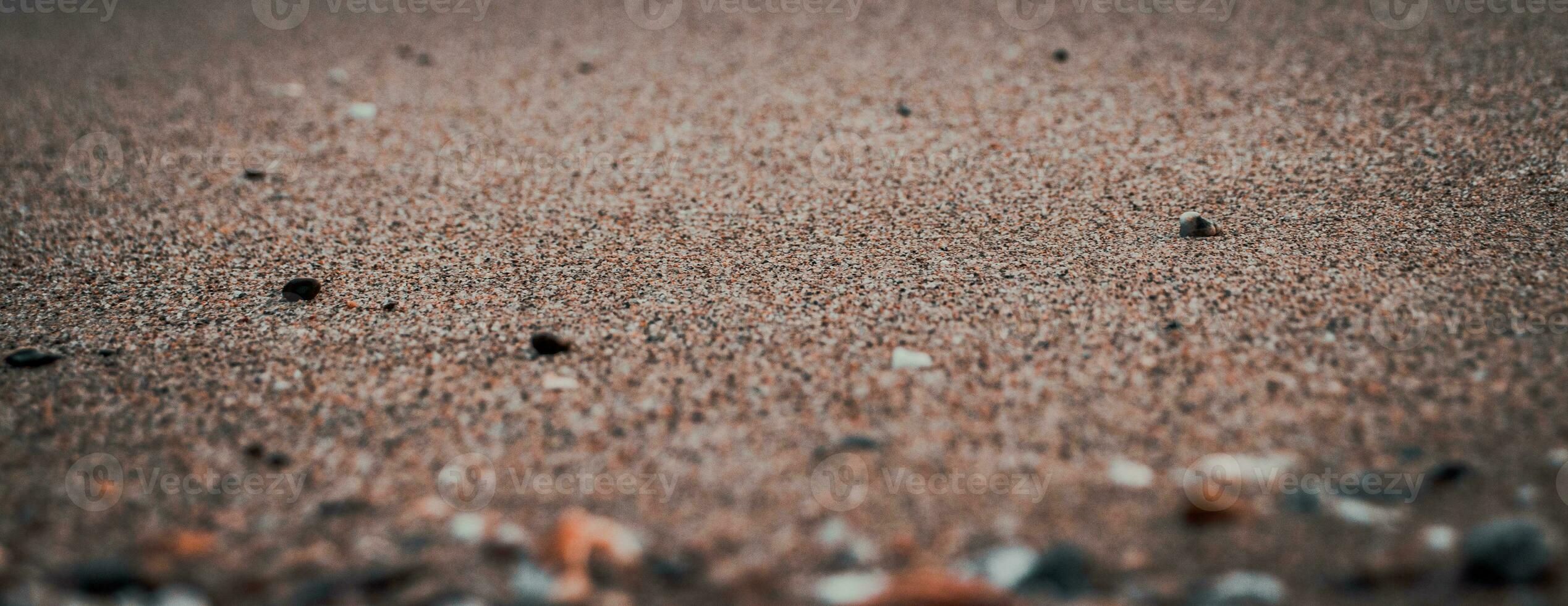 Close up sand beach background concept photo. Colorful small sea stones on the beach. photo