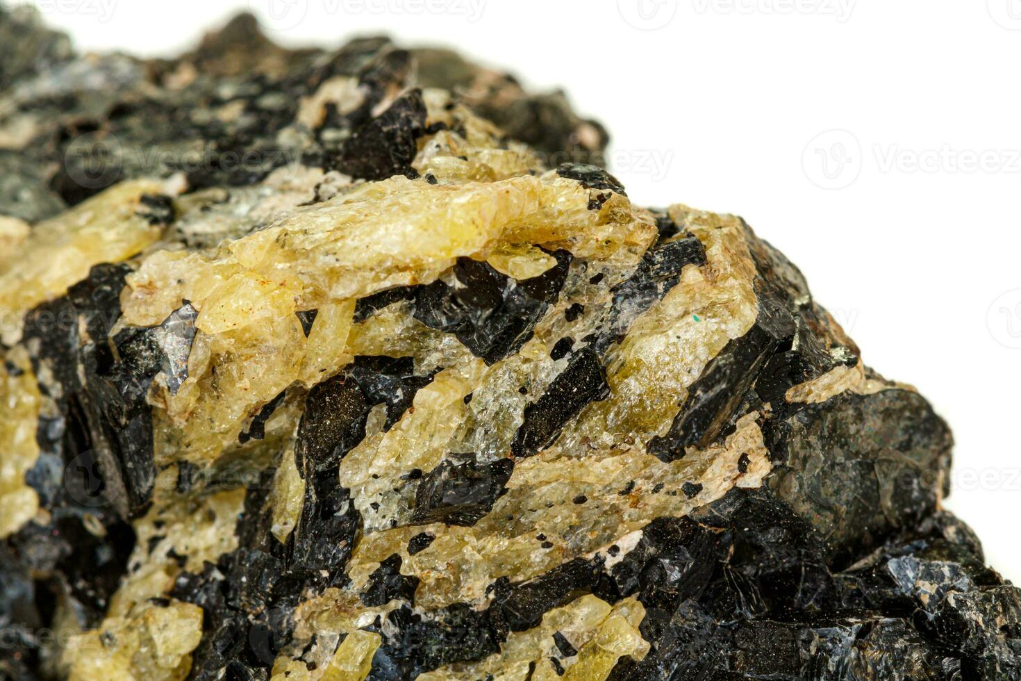 Macro of a mineral stone Vesuvianite on a white background photo