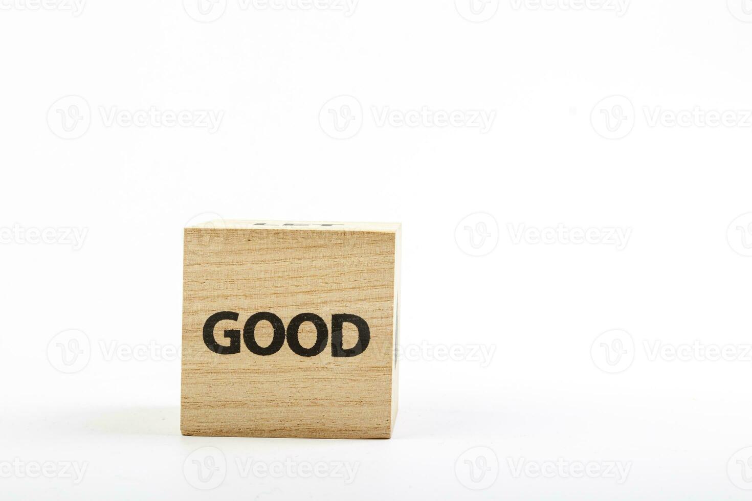 Wooden cubes with the inscription good on a white background photo