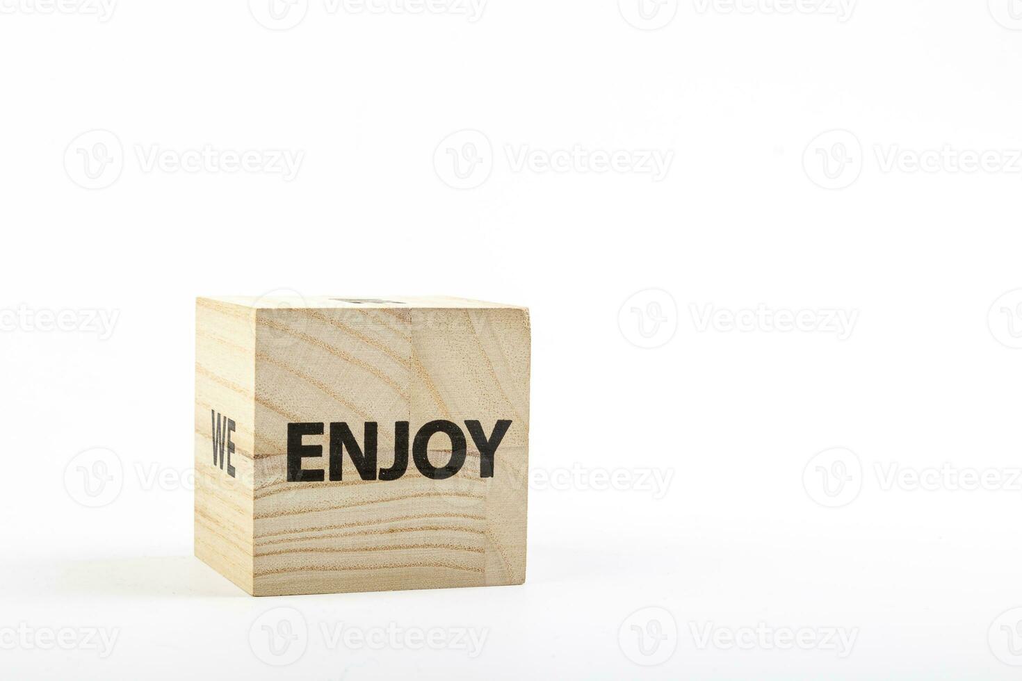 Wooden cubes with the inscription enjoy on a white background photo