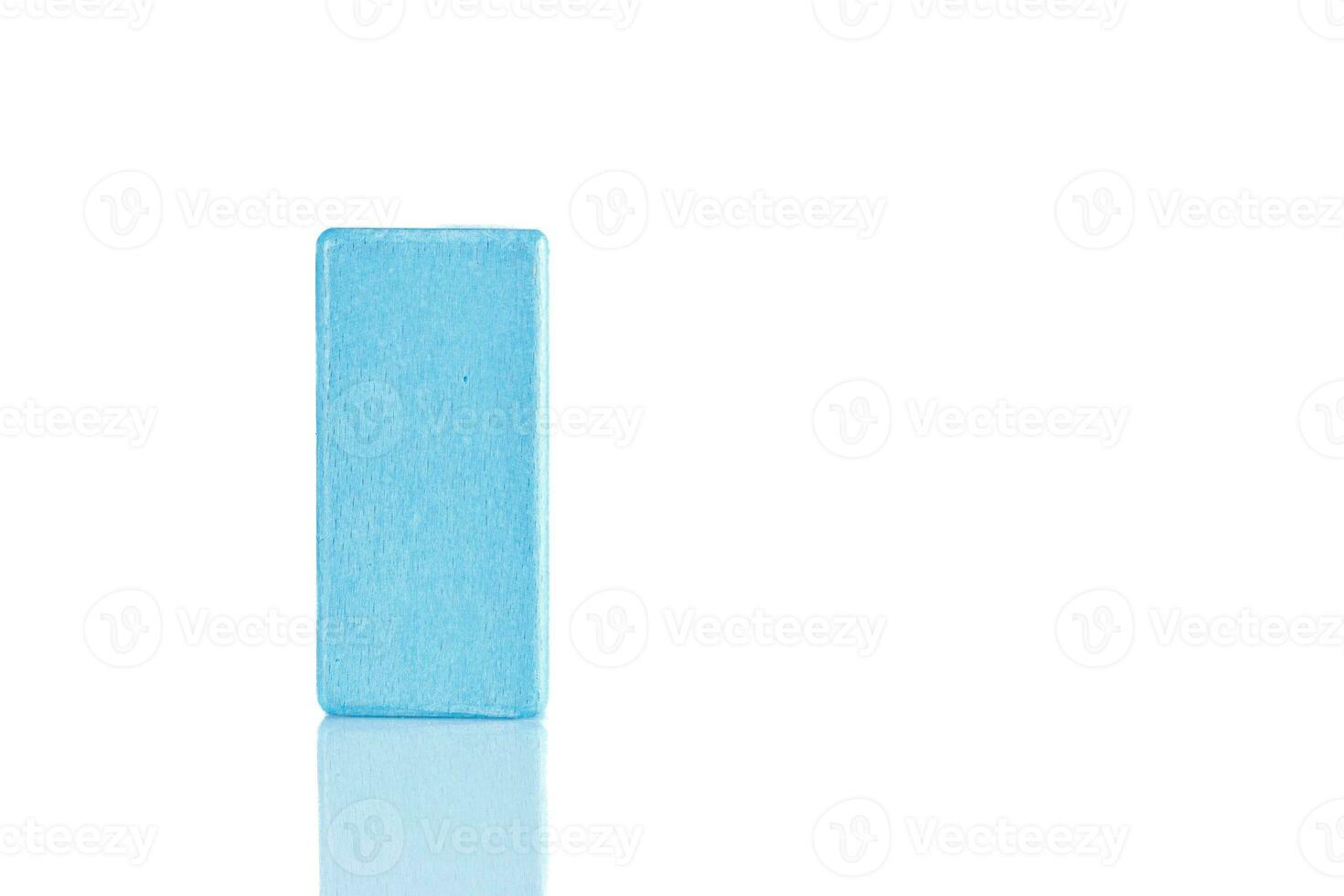 Wooden cube of blue color on a white background photo