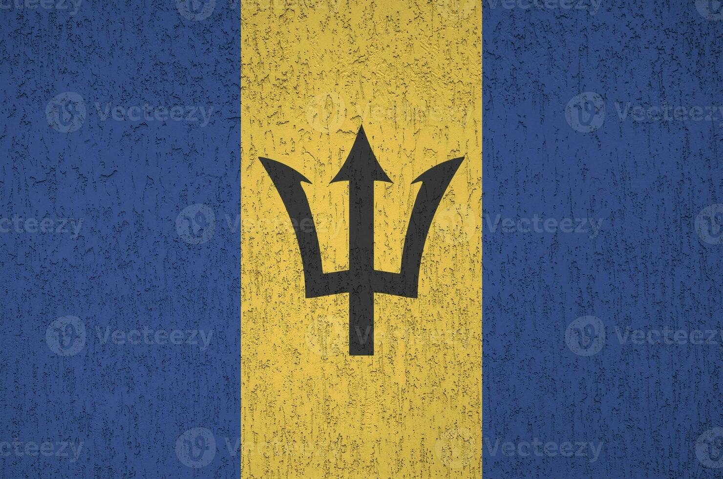 Barbados flag depicted in bright paint colors on old relief plastering wall. Textured banner on rough background photo