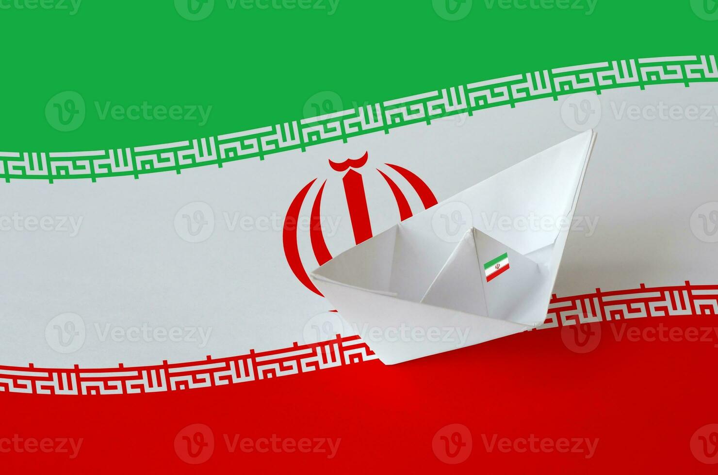 Iran flag depicted on paper origami ship closeup. Handmade arts concept photo