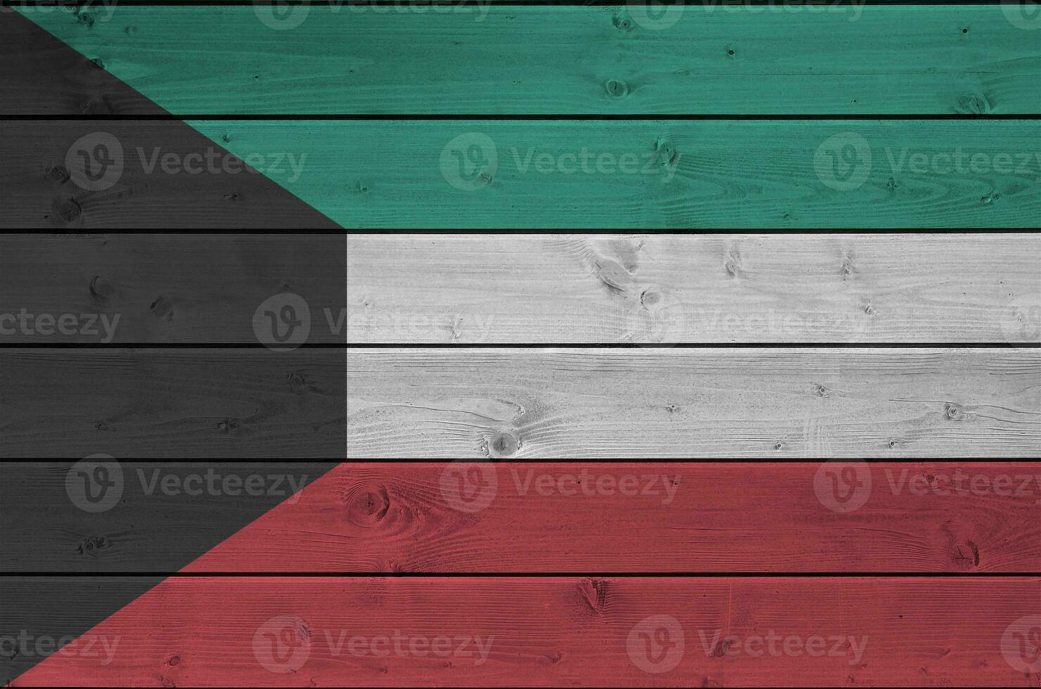 Kuwait flag depicted in bright paint colors on old wooden wall. Textured banner on rough background photo