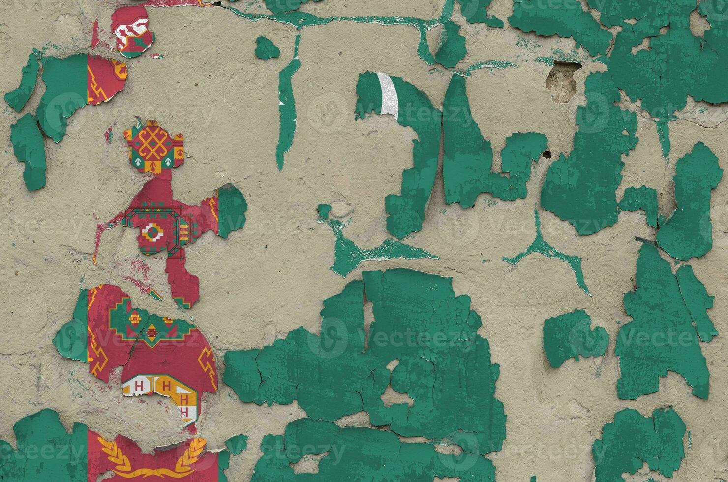 Turkmenistan flag depicted in paint colors on old obsolete messy concrete wall closeup. Textured banner on rough background photo