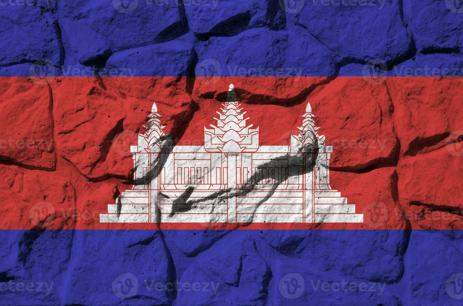 Cambodia flag depicted in paint colors on old stone wall closeup. Textured banner on rock wall background photo