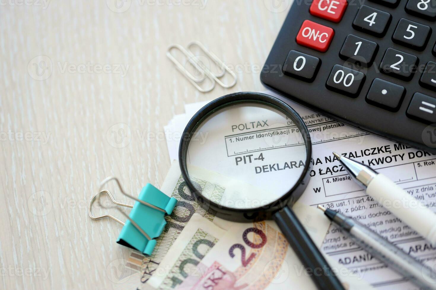 Declaration of a monthly advance payment for income tax on the total amount of payments, PIT-4 form on accountant table with pen and polish zloty money bills photo
