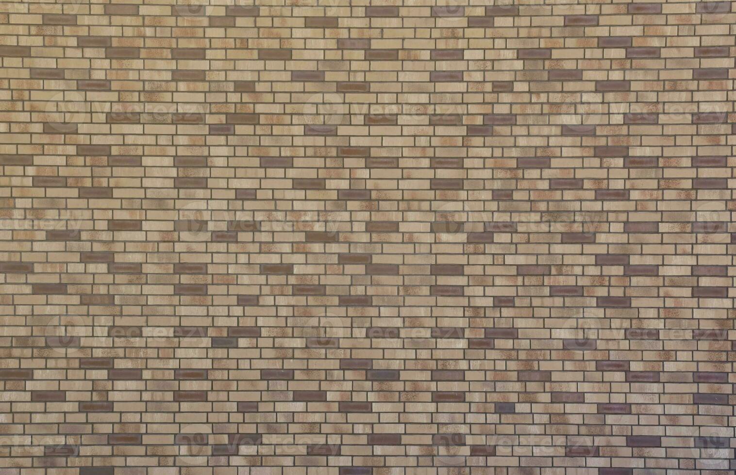 Dark brick wall pattern with chaotic masonry order. Background texture or resource for 3d texturing. Many bricks in big modern stone wall photo