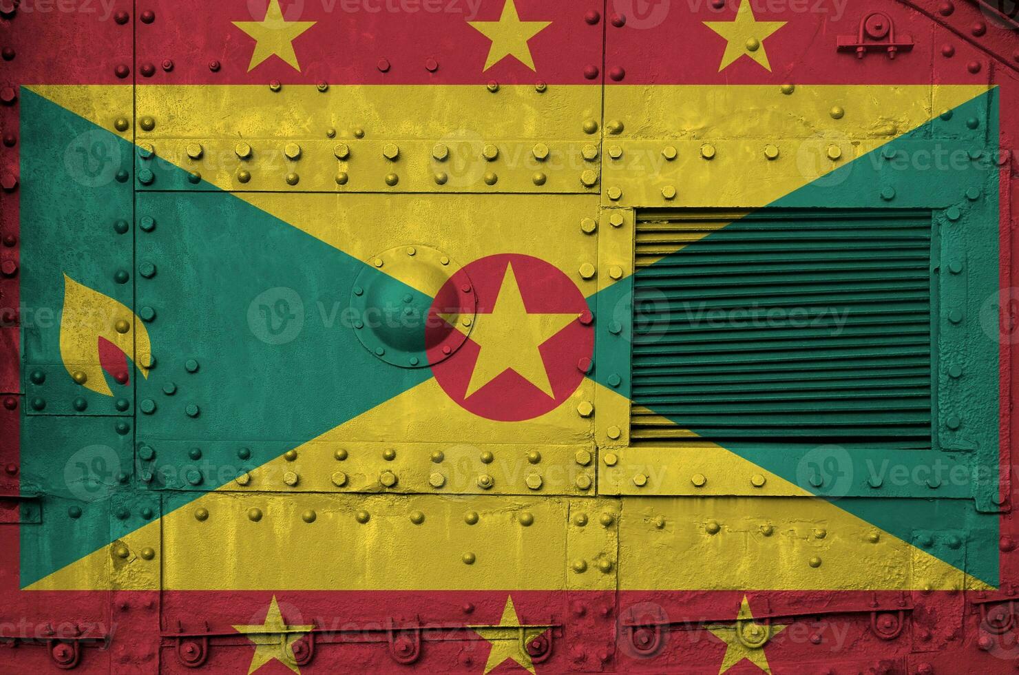 Grenada flag depicted on side part of military armored tank closeup. Army forces conceptual background photo