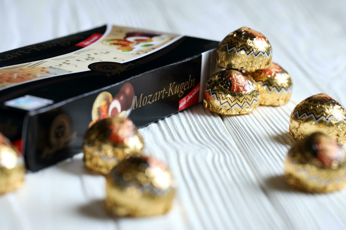KHARKOV, UKRAINE - April 19, 2021 Henry Lambertz Mozart-Kugeln luxury dark chocolate candies in black box on white table photo