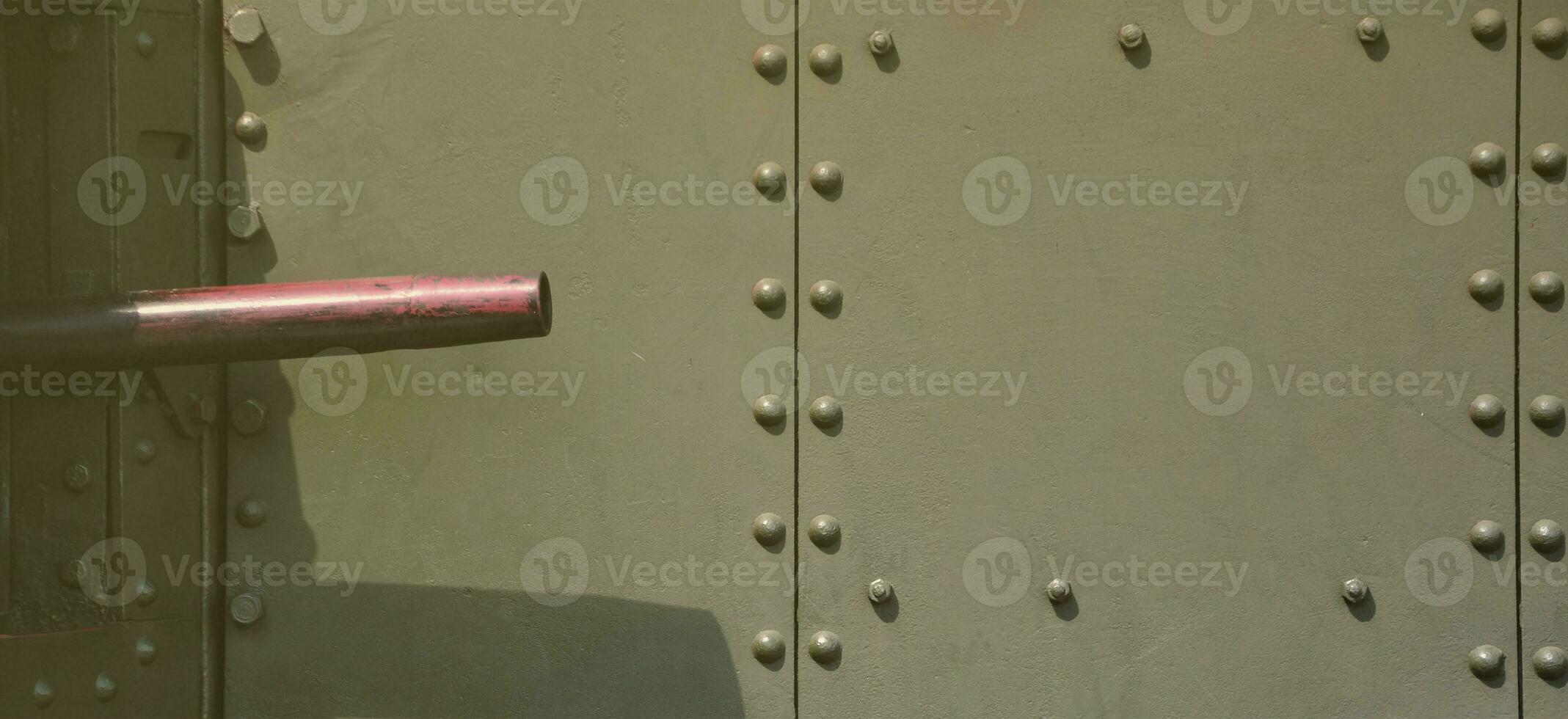 The texture of the wall of the tank, made of metal and reinforced with a multitude of bolts and rivets. Images of the covering of a combat vehicle from the Second World War with a guided machine gun photo