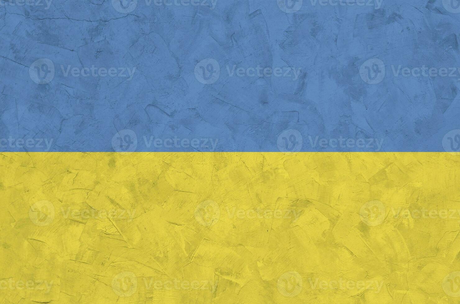 Ukraine flag depicted in bright paint colors on old relief plastering wall. Textured banner on rough background photo