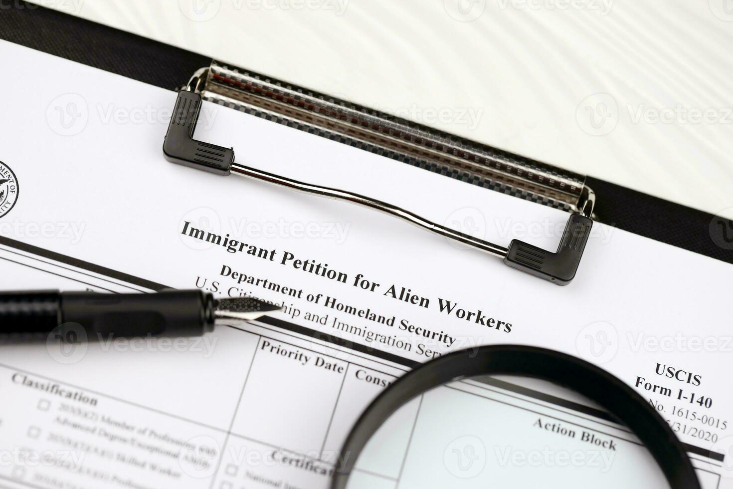 I-140 Immigrant petition for alien workers blank form on A4 tablet lies on office table with pen and magnifying glass photo