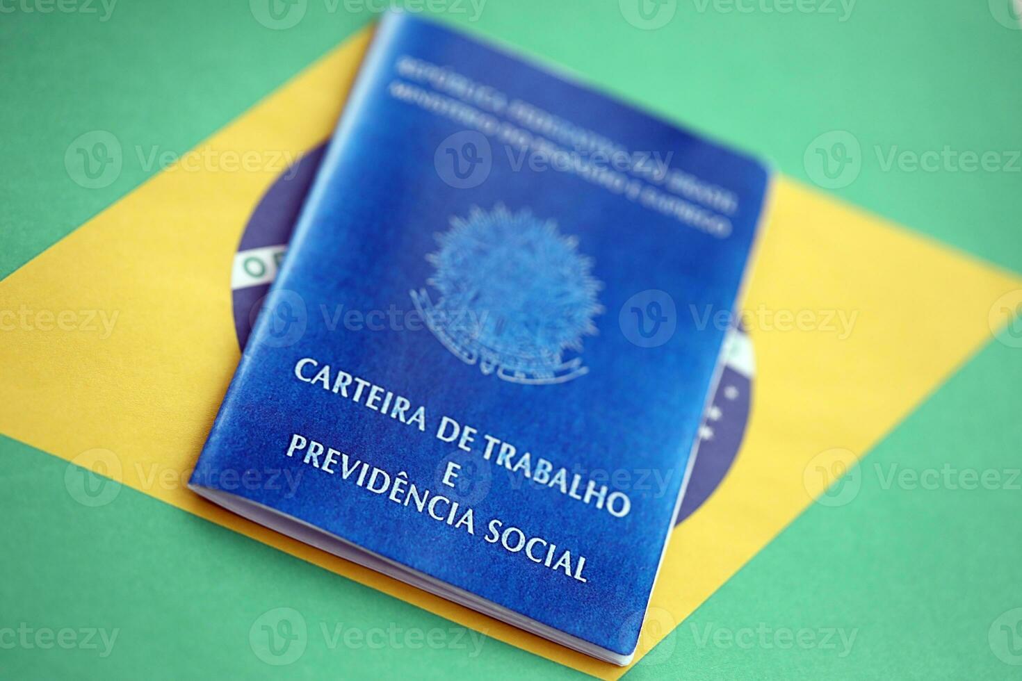Brazilian work card and social security blue book on flag of Federative Republic of Brazil photo