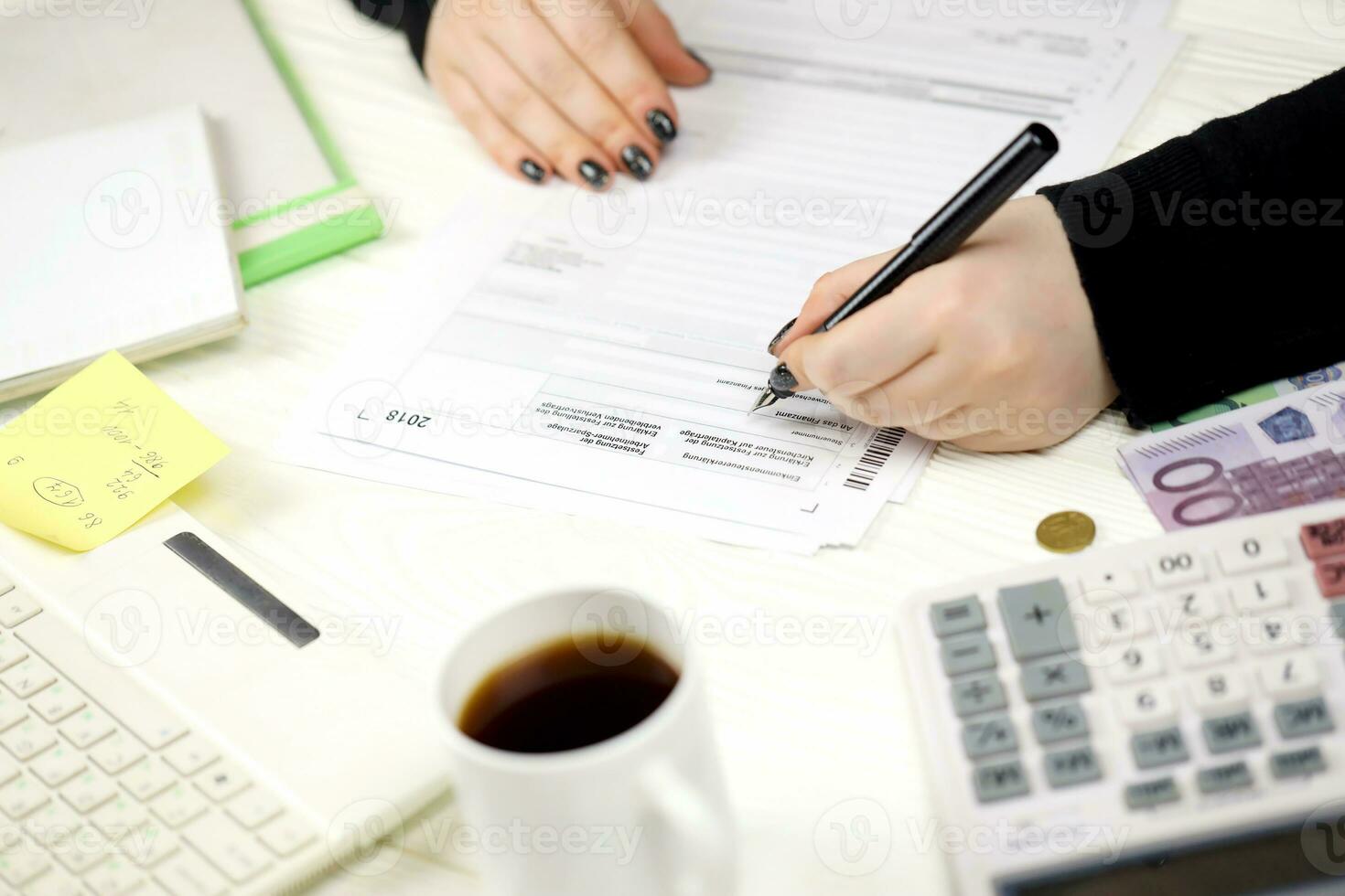 Accountant fill german tax form Einkommensteuererklarung in end of tax period. Taxation and paperwork routine photo