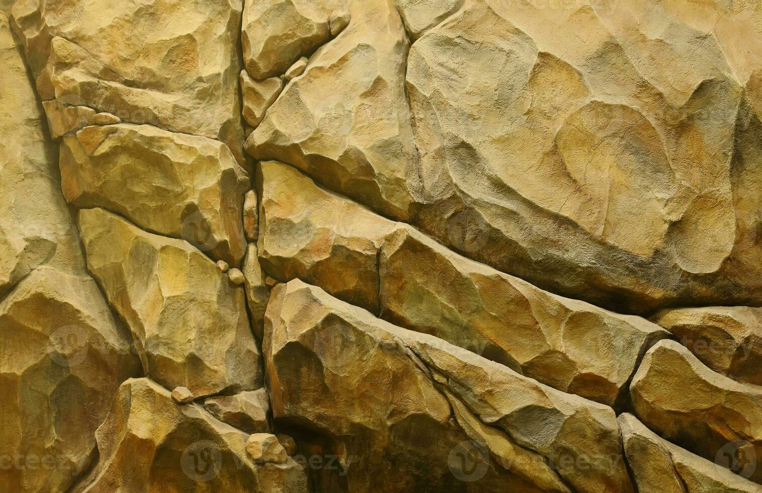 Light coarse natural rock stone background. Mining cliff rough front surface. Big limestone stack backdrop. Heavy grunge damaged granite block texture photo