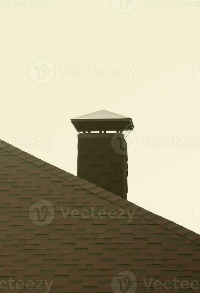 The roof covered with a modern flat bituminous waterproof coating isolated on white photo