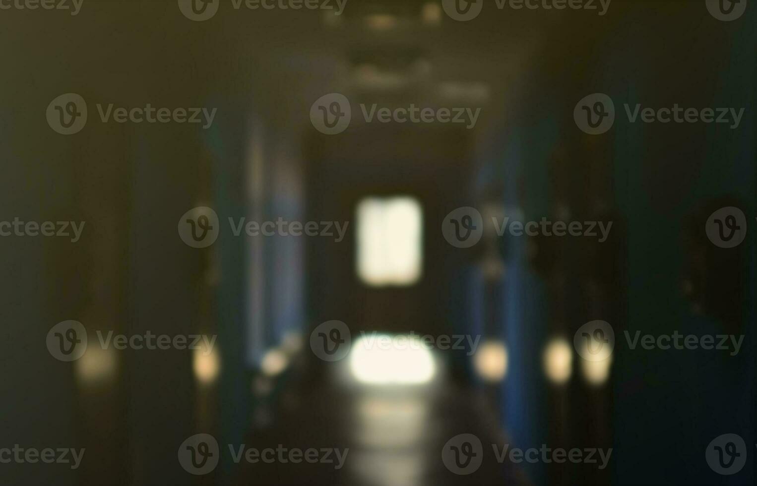 The blurred image of gloomy corridor of a neglected public building. Defocused picture of a public space in a poor residential high-rise building photo