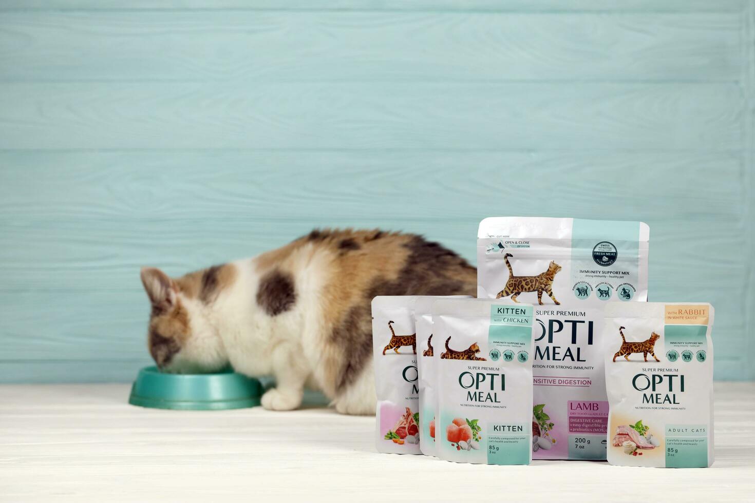 KHARKIV, UKRAINE - JANUARY 2, 2021 Optimeal cat meal packs. Optimeal is product by Kormotech LLC, a global family company, the largest producer of pet food in Ukraine photo