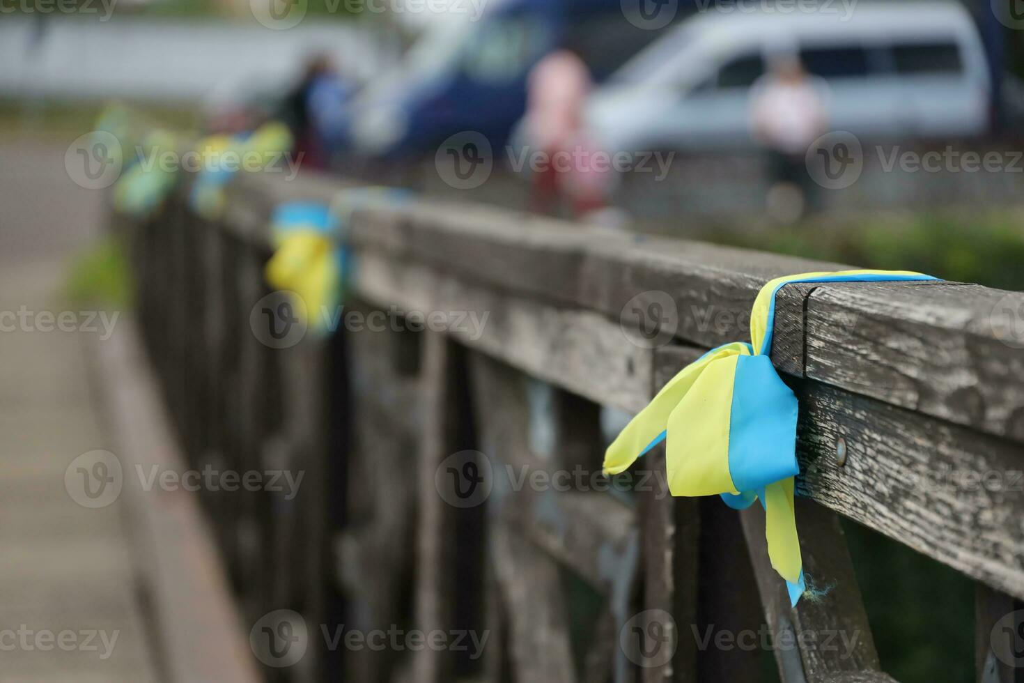 Ribbons in the colors of the national flag of Ukraine are tied to the handrail photo