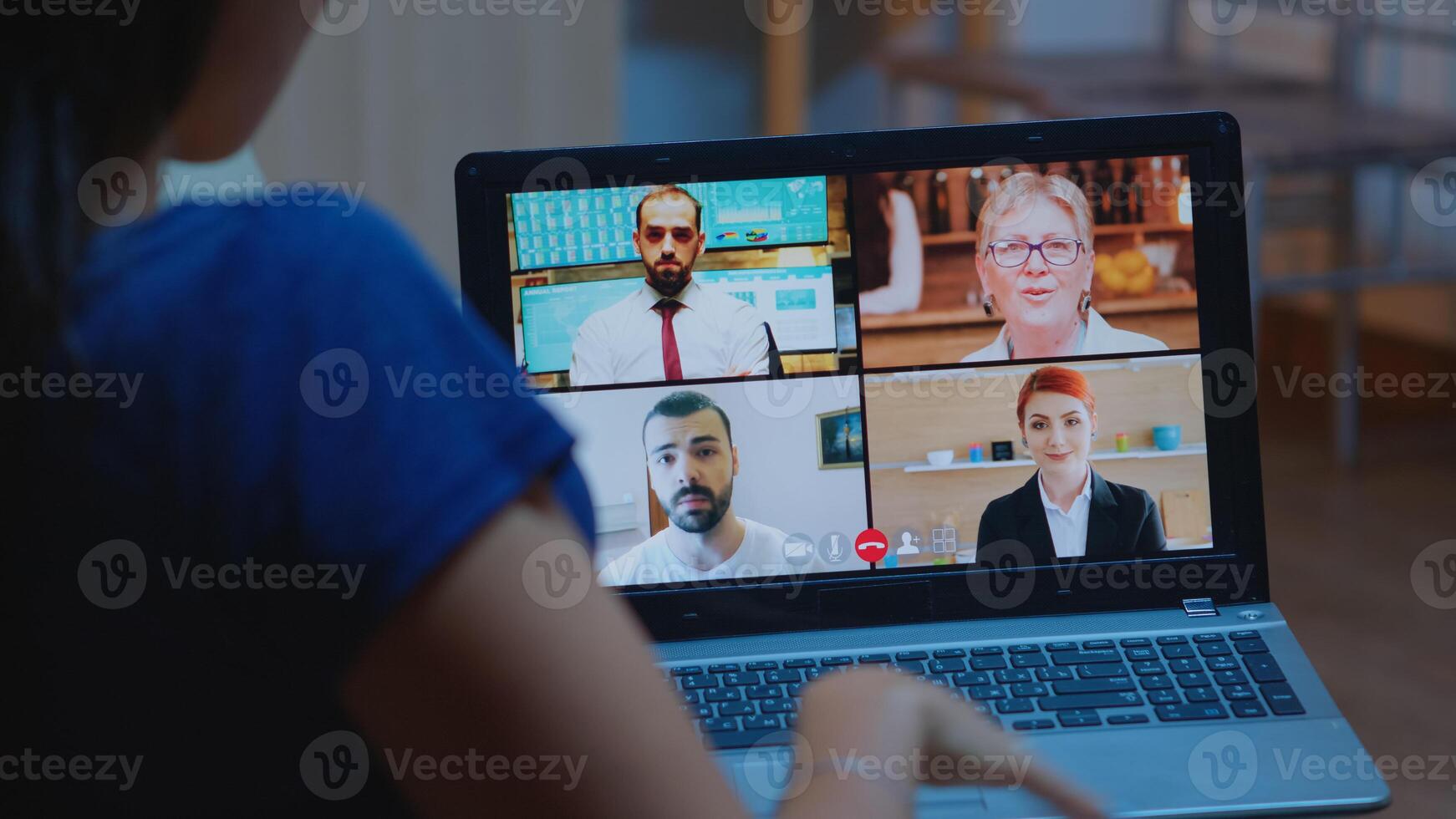 Freelancer having video conference at night with team sitting on couch using laptop. Remote worker discussing at online meeting, consulting with colleagues using videocall and webcam working from home photo