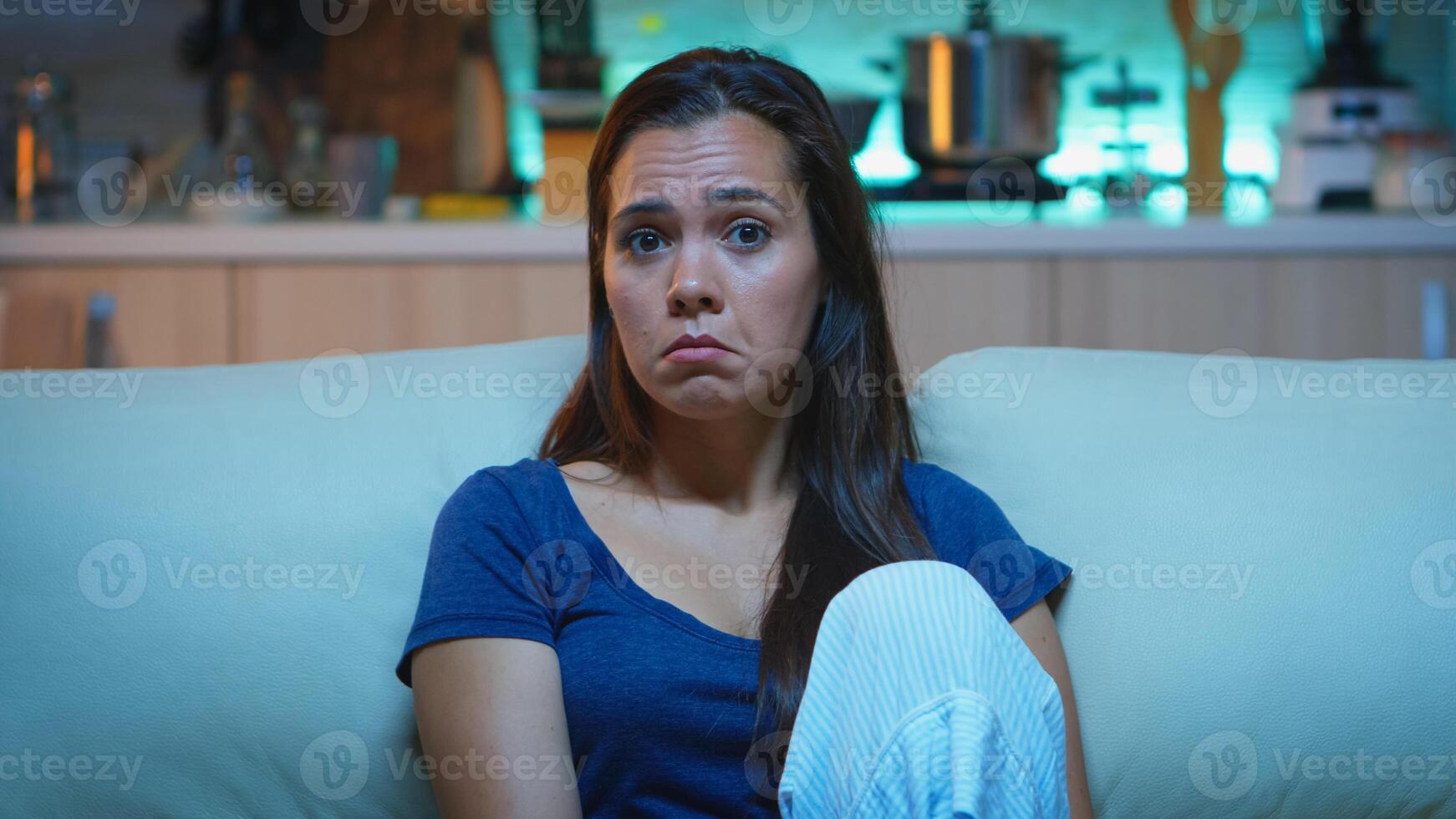 Focused young woman paying attention to film with a shocked concentrated and amazed facial expression. Emotionally awestruck and wide-eyed lady reacting to an impressive and astonishing moment on tv photo