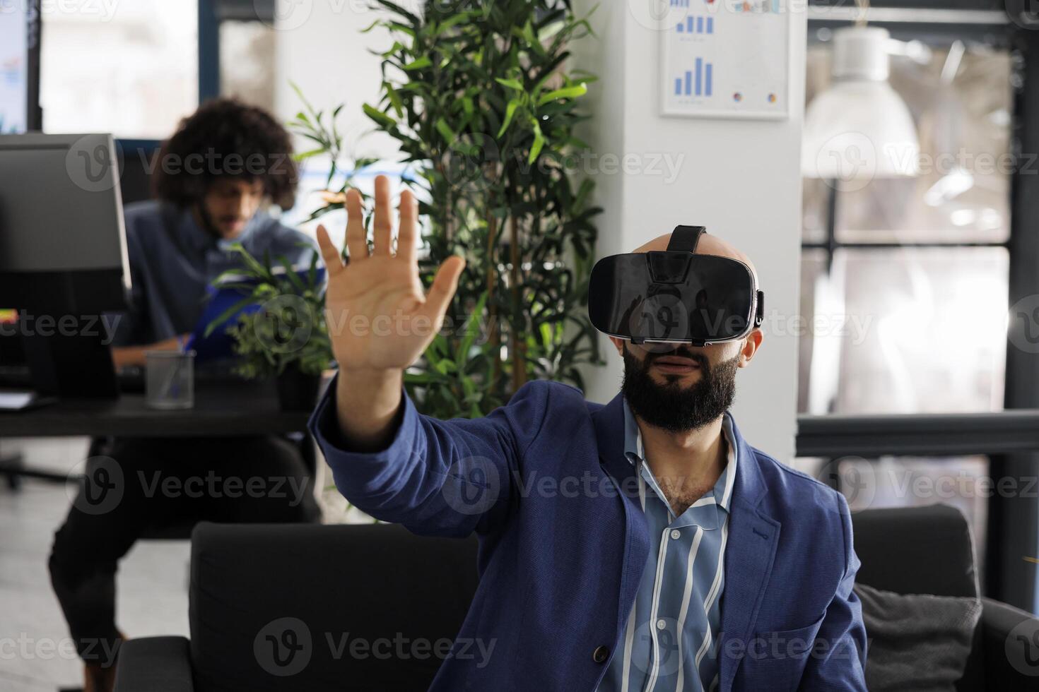 Executive manager using vr glasses for strategy testing in metaverse while working in coworking space. Entrepreneur exploring virtual reality and brainstorming in business office photo