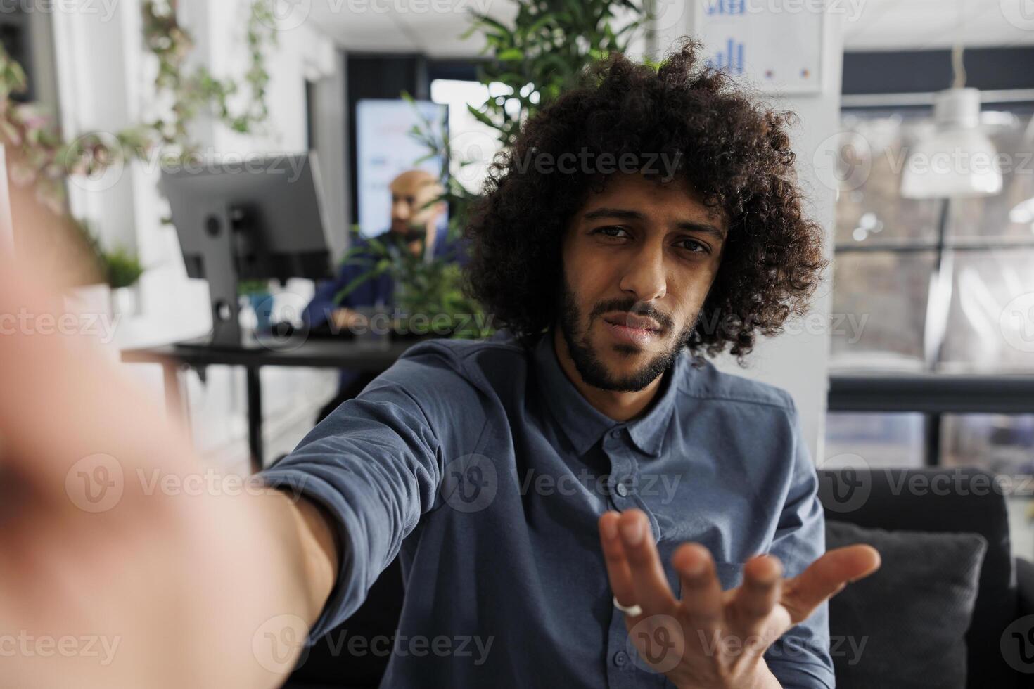 Confused start up company product manager discussing project with client on smartphone videocall and looking at camera. Business entrepreneur explaining analytics report to customer on mobile phone photo
