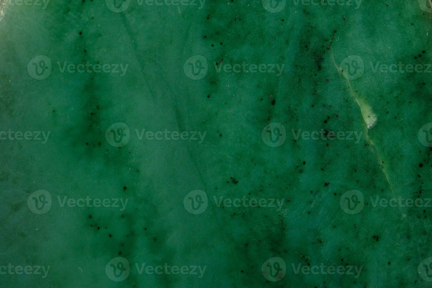 Macro stone Nephrite mineral on black background photo