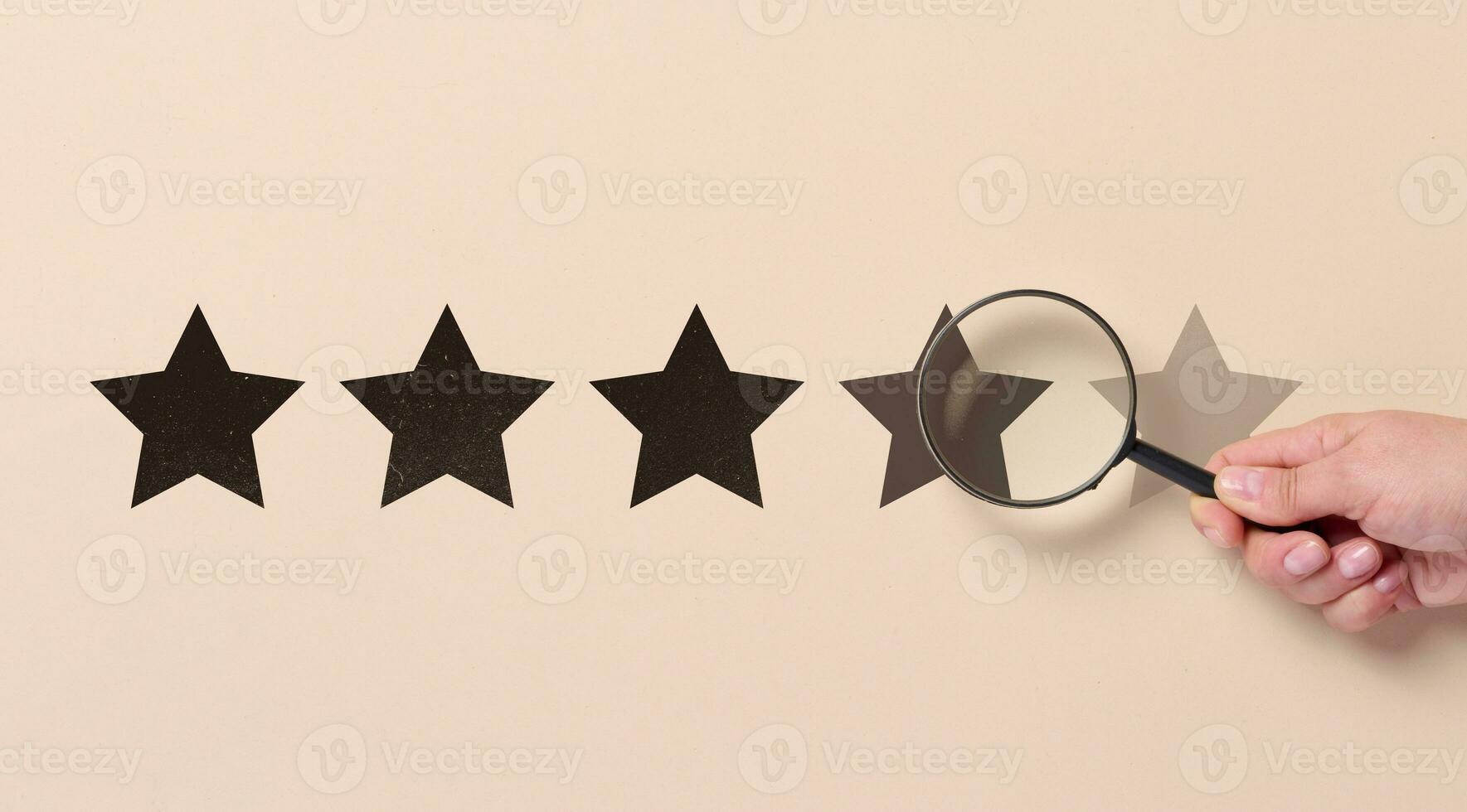 Five star rating and a magnifying glass in a woman's hand. Customer reviews photo