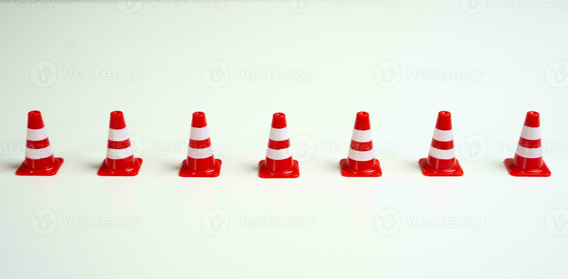 Row of traffic cones on a white background. Create a new restriction. Provide new sanctions and restrictions. Laws and regulations. Bans and taboo. Stop work, freeze and cancel. Block VPN services. photo