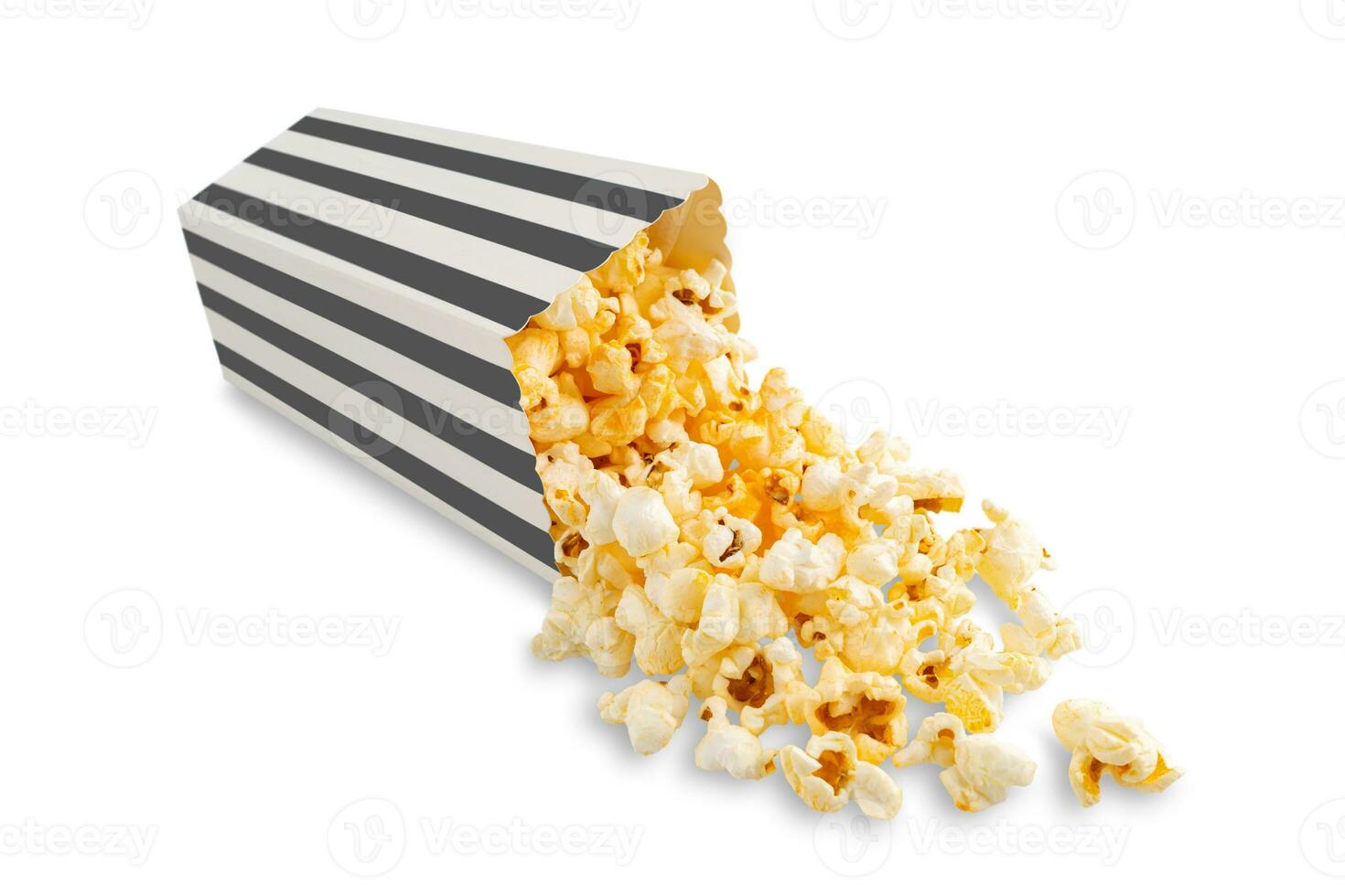 Tasty cheese popcorn falling out of a black striped carton bucket, isolated on white background photo