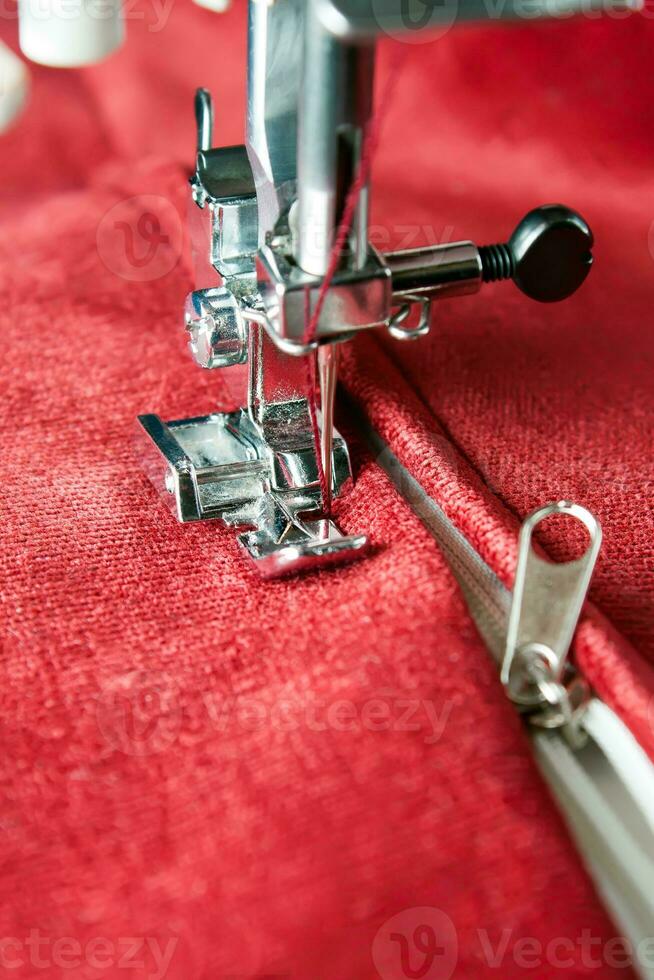 Modern sewing machine presser foot and zipper. Sewing process photo