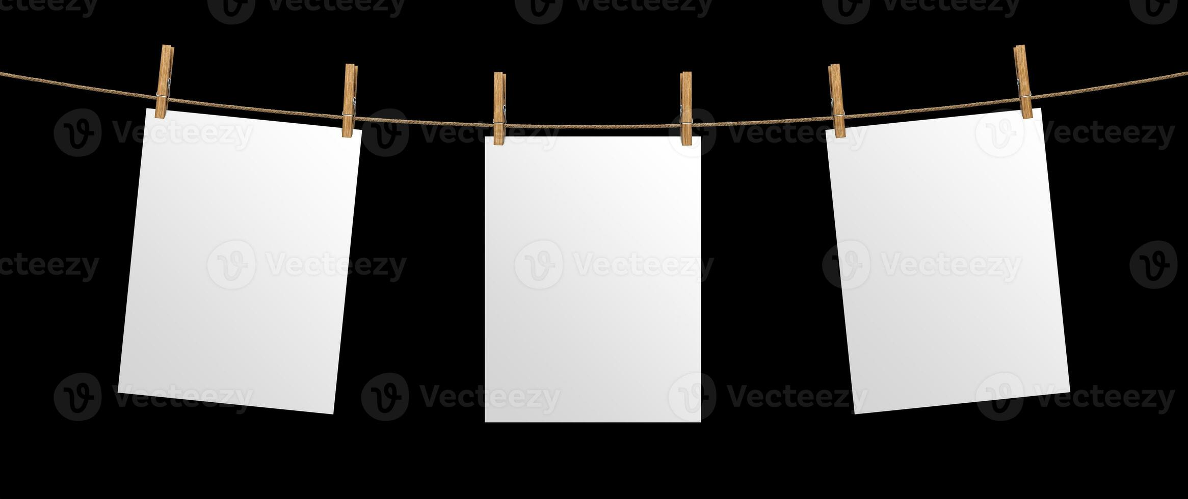 Empty paper sheet hanging on rope, isolated on black background, mock up for your project, poster template photo