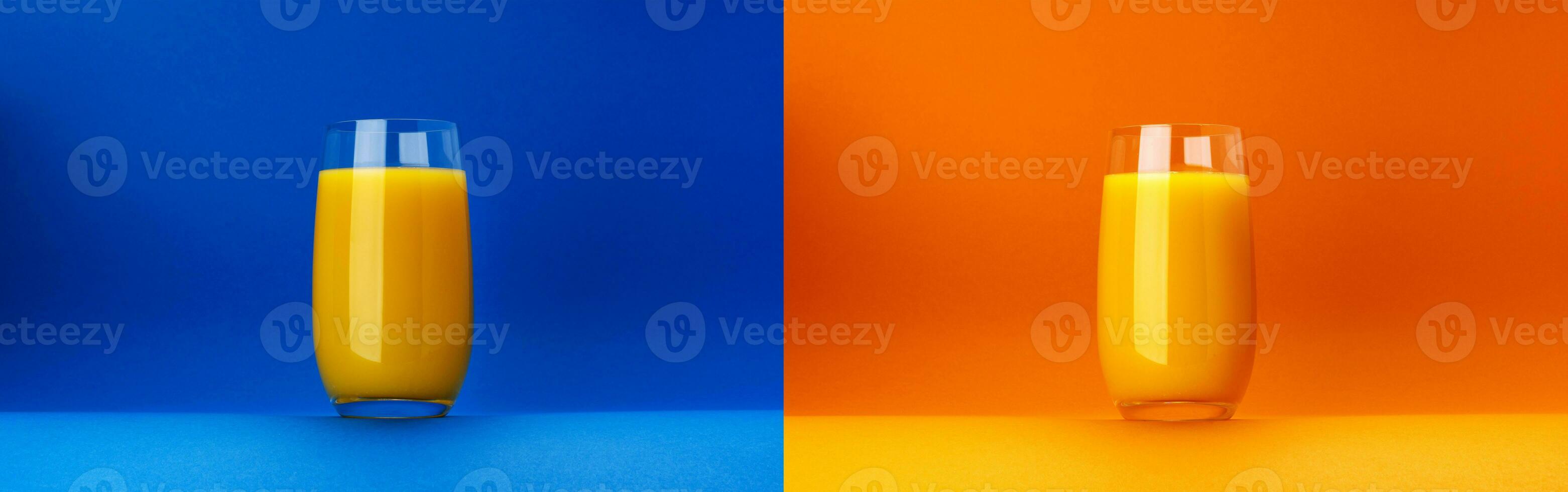 Glass of orange juice isolated on orange and blue backgrounds with copy space photo