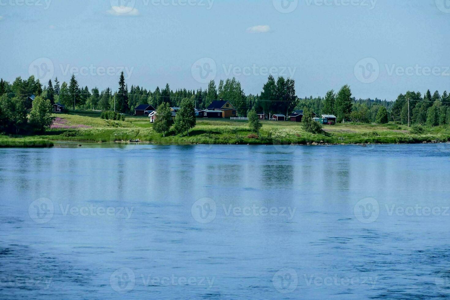 a river with a house on the shore photo