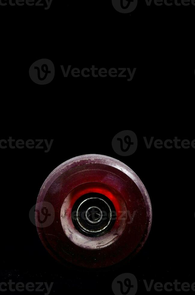 a red plastic wheel with a black background photo