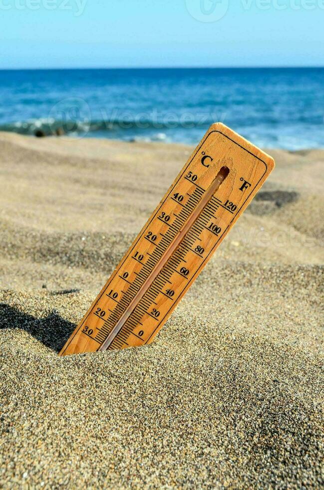 a thermometer on the beach photo