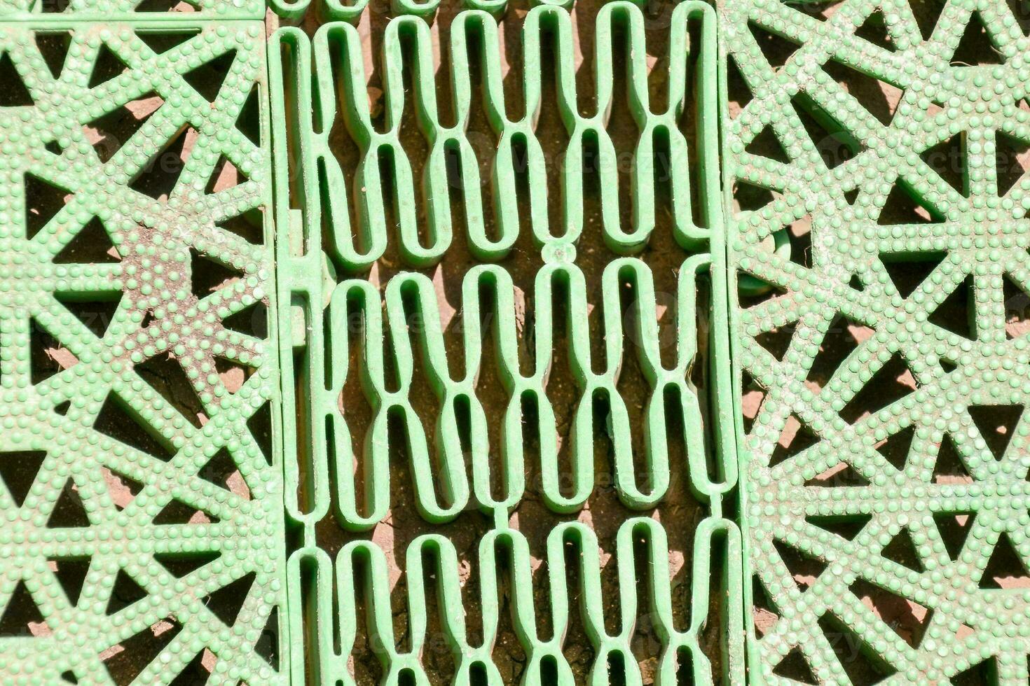 a close up of a green metal grate photo